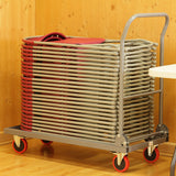 Burgundy fan back plastic folding chairs stacked on chair trolley.