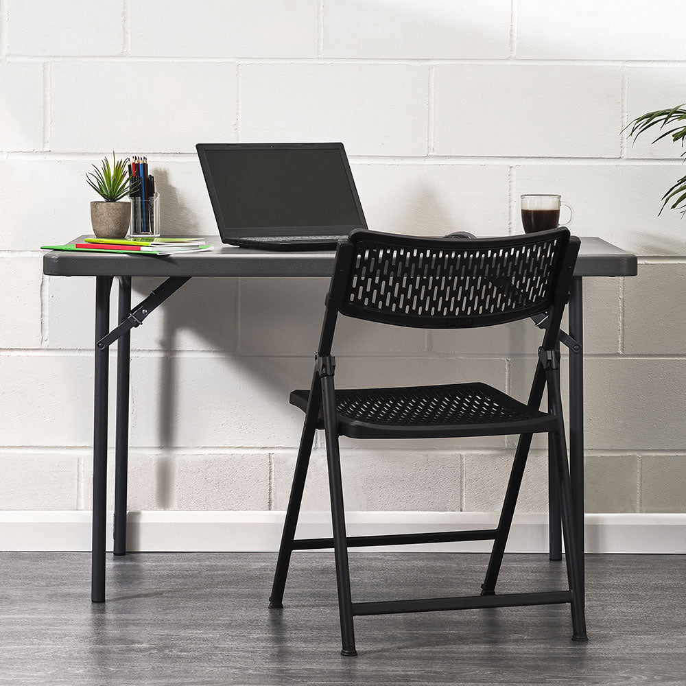 Aran Black Contemporary Plastic Folding Chair in Home Office Setting.