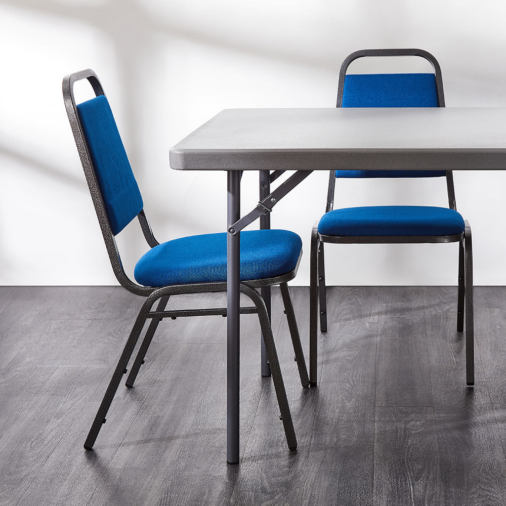 Blue banqueting chairs around a grey folding table.