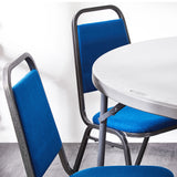 Detail of blue banqueting chairs around  a folding table.