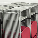 Detail of plastic folding chairs hanging on chair trolley for storage.
