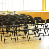 Rows of black Smart Folding Chairs in community centre.
