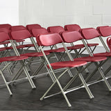 Burgundy Plastic Folding Chairs in Rows.