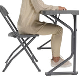 Person seated at Zown M183 narrow folding table, demonstrating legroom beneath the tabletop