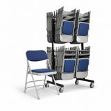 A single folding chair with blue padded seat and back is shown beside a black rolling rack holding many matching folded chairs on a white studio background.