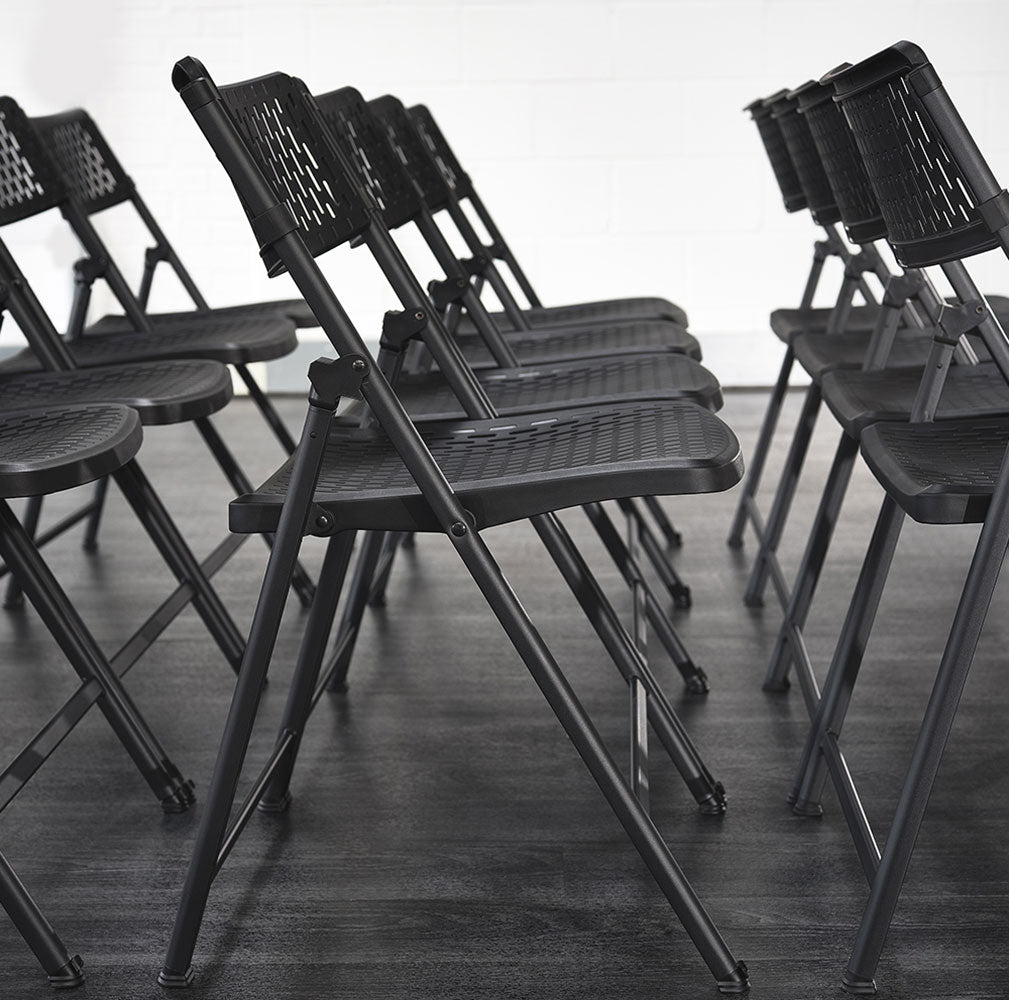 Aran Black Plastic Folding Chairs in Rows.