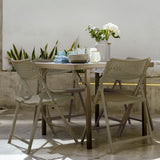 Aran Grey Contemporary Plastic Folding Chairs in Outdoor Setting with Table.