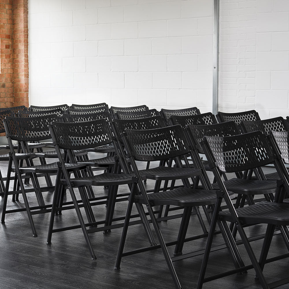 Aran Black Contemporary Plastic Folding Chairs in Rows.