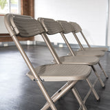 BigClassic Grey Plastic Folding Chairs in a Row.