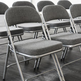Grey Comfort Deluxe folding chairs in rows.