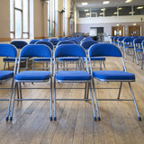 Rows of Comfort Deluxe padded folding chairs in community hall.