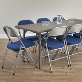 Blue Comfort Deluxe padded folding chairs set around a folding meeting table.