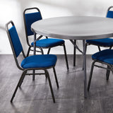 Blue banqueting chairs around a round folding table.