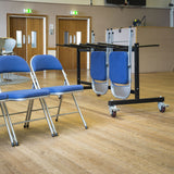 Folding chair trolley ready for use in community centre hall.